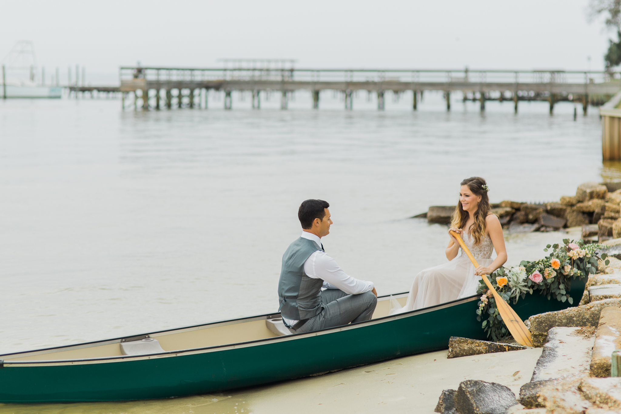 Destin Bay House bride and groom in a canoe